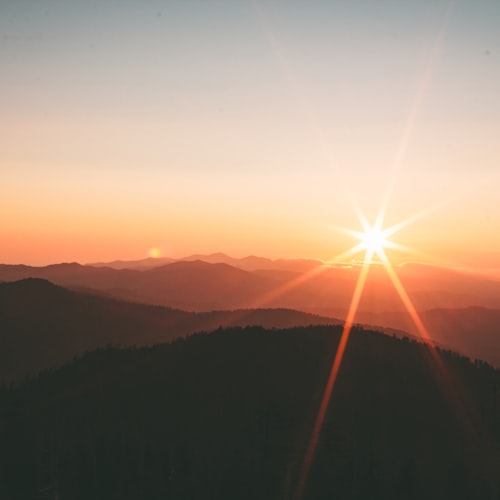 Warm orange sunset over mountains - top-left of a planned Instagram grid
