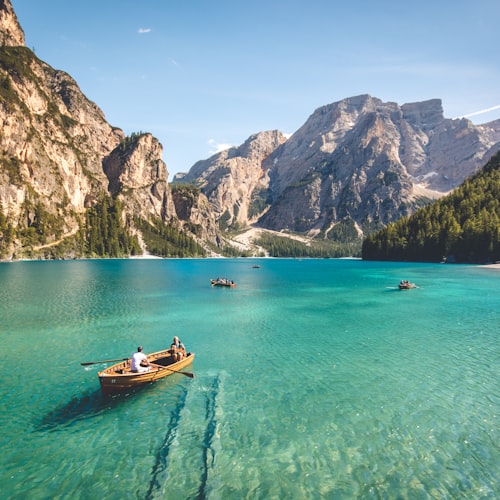 Teal mountain lake bridging green into blue